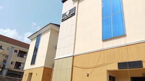 A hotel building with a sign reading "DEGOK HOTEL LIMITED". - Degok Hotel (Abuja)