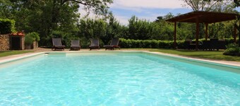 Portion of an old stone country house, well-kept garden and private swimming pool. Situated a few km