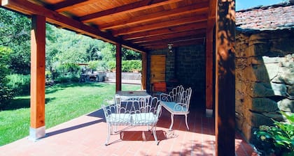 Portion of an old stone country house, well-kept garden and private swimming pool. Situated a few km