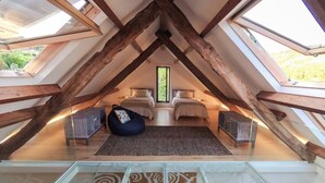 A bedroom with two beds, a glass ceiling, and wooden beams. - A Unique Home, For A Truely Unique Experience (Mos)