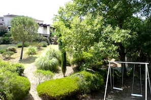 Escape to a serene garden oasis with a tranquil swing set and peaceful surroundings.