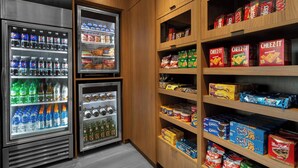 A vending area with Pepsi, water, and other beverages, and shelves stocked with snacks and food items. - Fairfield Inn & Suites Kenosha Pleasant Prairie (Pleasant Prairie)