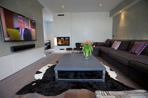 TV room with flat screen TV & live fire