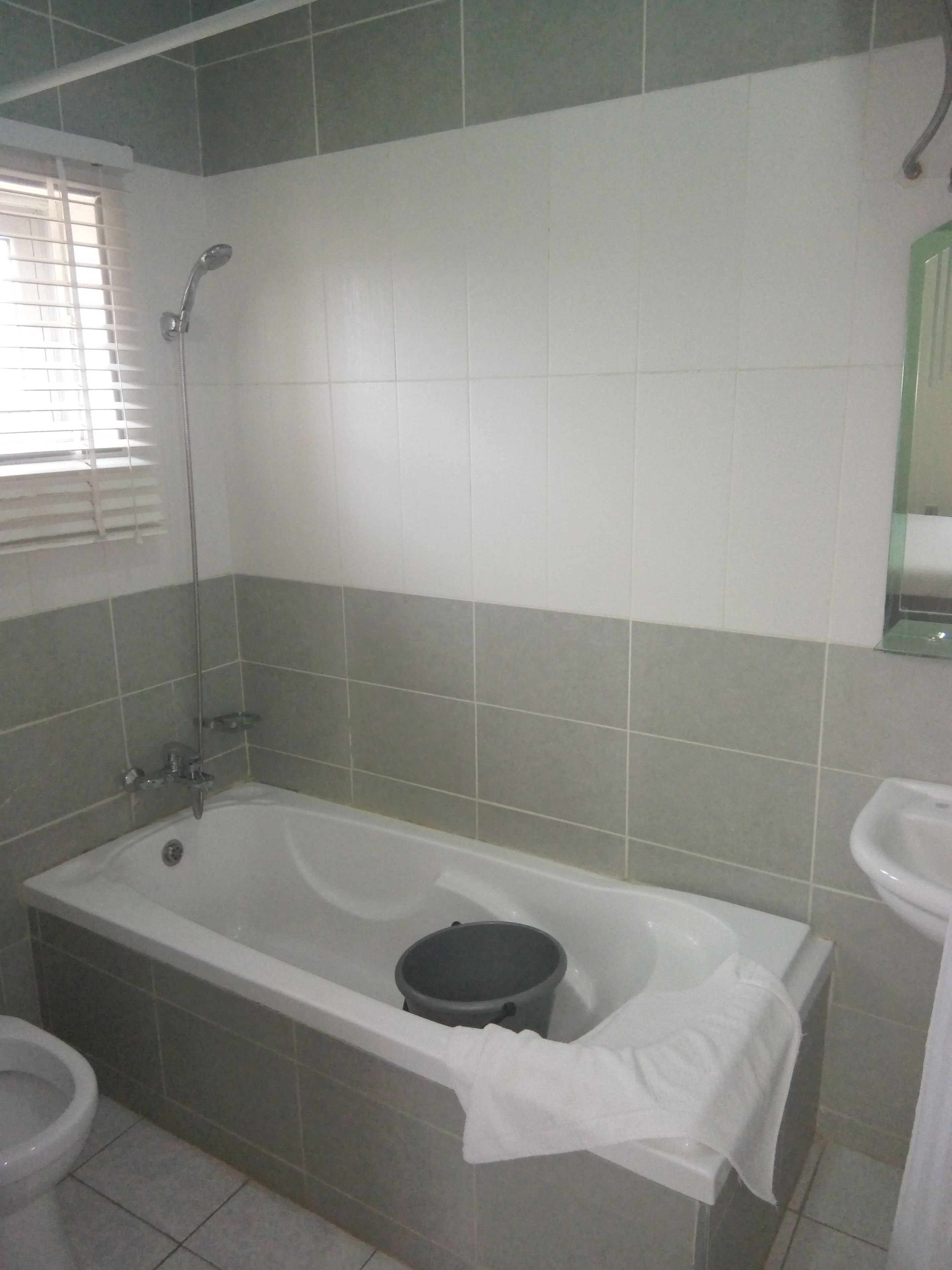 A bathroom with a bathtub, a toilet, and a sink.