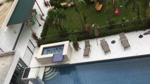 A swimming pool with lounge chairs and a small deck area. - Perfect Havens at Platinum 5 (Lagos)