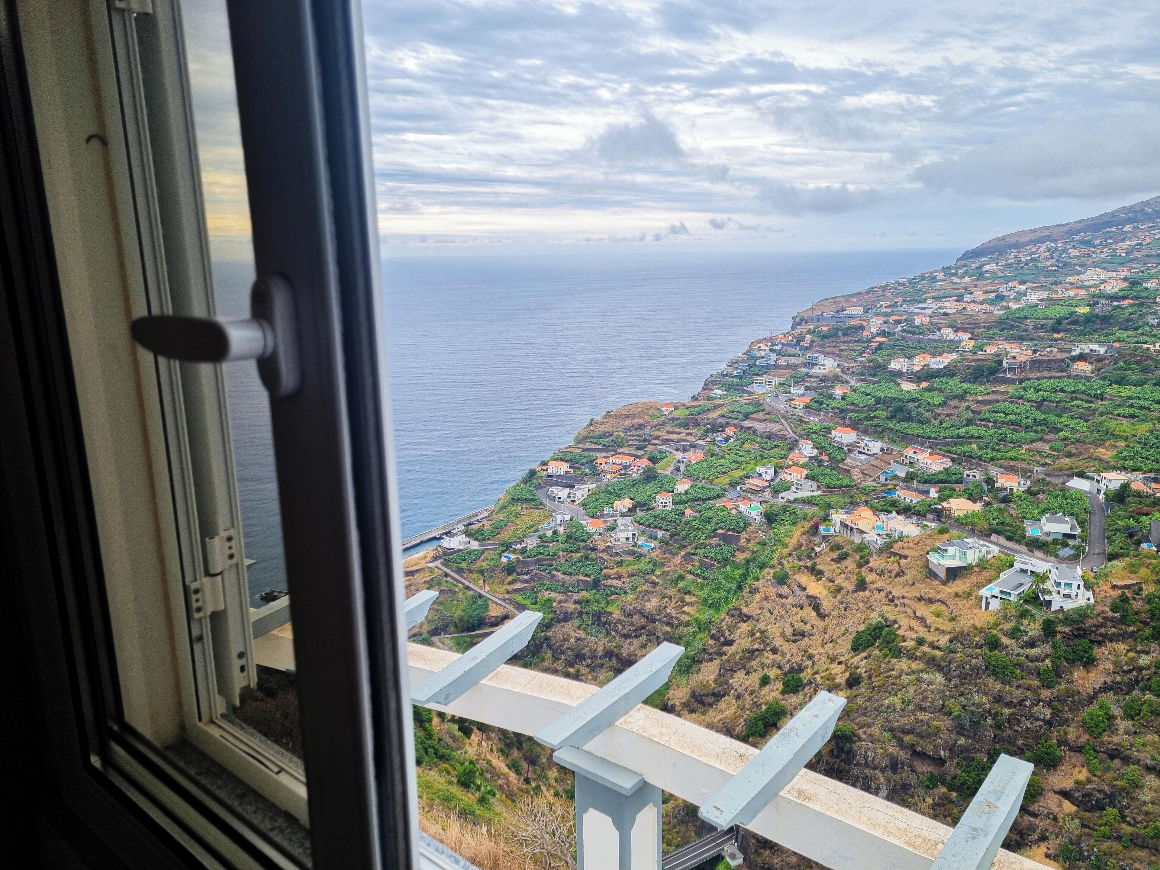 A coastal town with a view of the sea and a bridge.