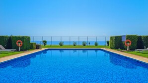 A swimming pool with a clear view of the sea in the background. - 405 Luxury 4 Bed Penthouse, Heated 20m Pool-Front Line-Paseo-Bikes-BBQ-Hot Tub (Estepona)