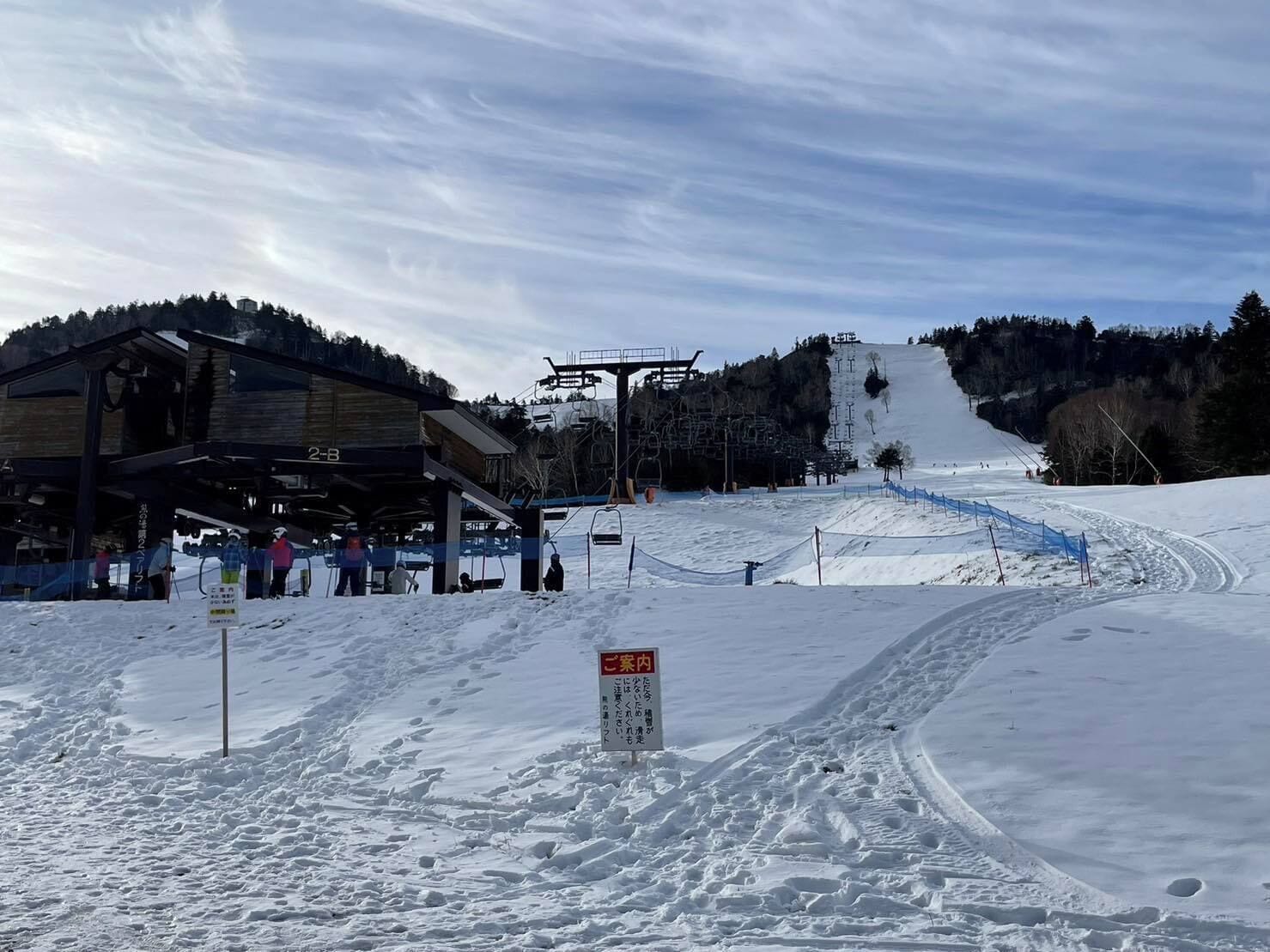 Una stazione sciistica con una stazione di risalita, skilift e una pista innevata.