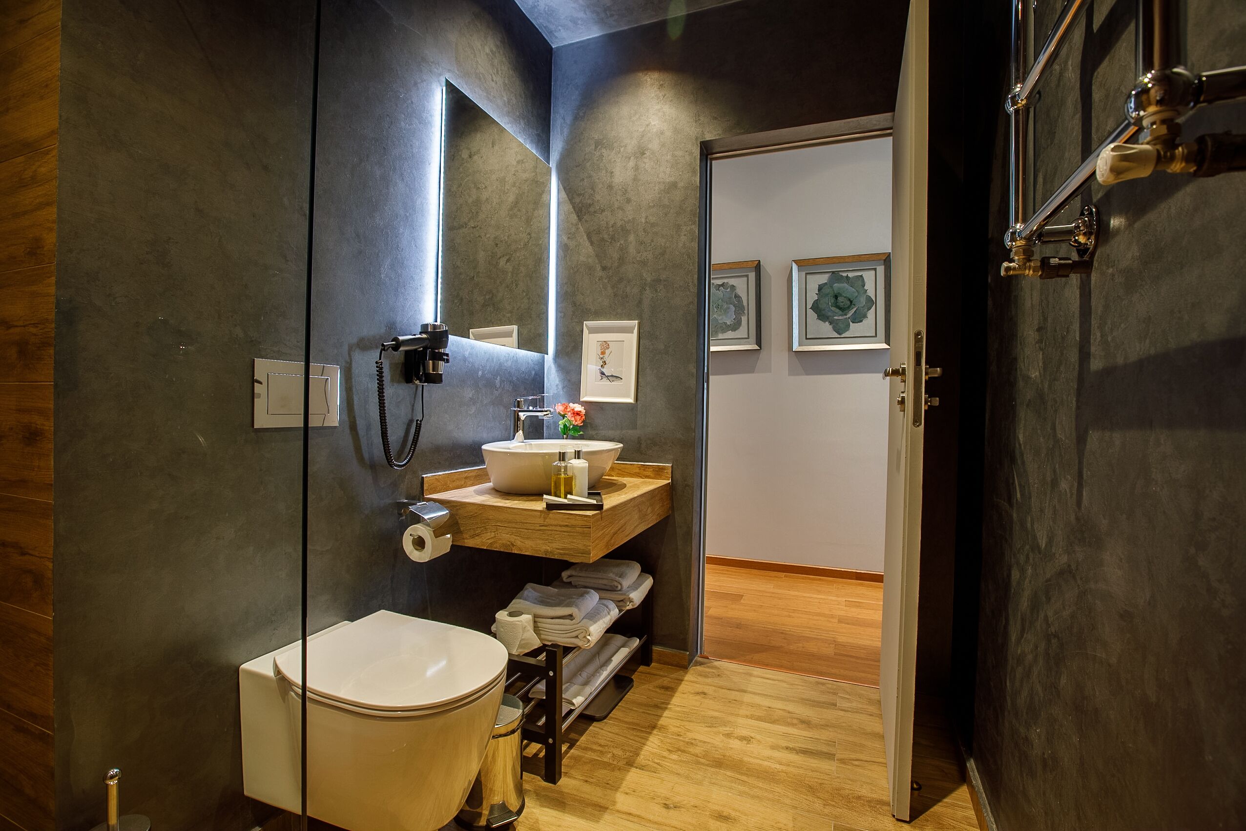 A modern bathroom with a toilet, sink, and mirror.