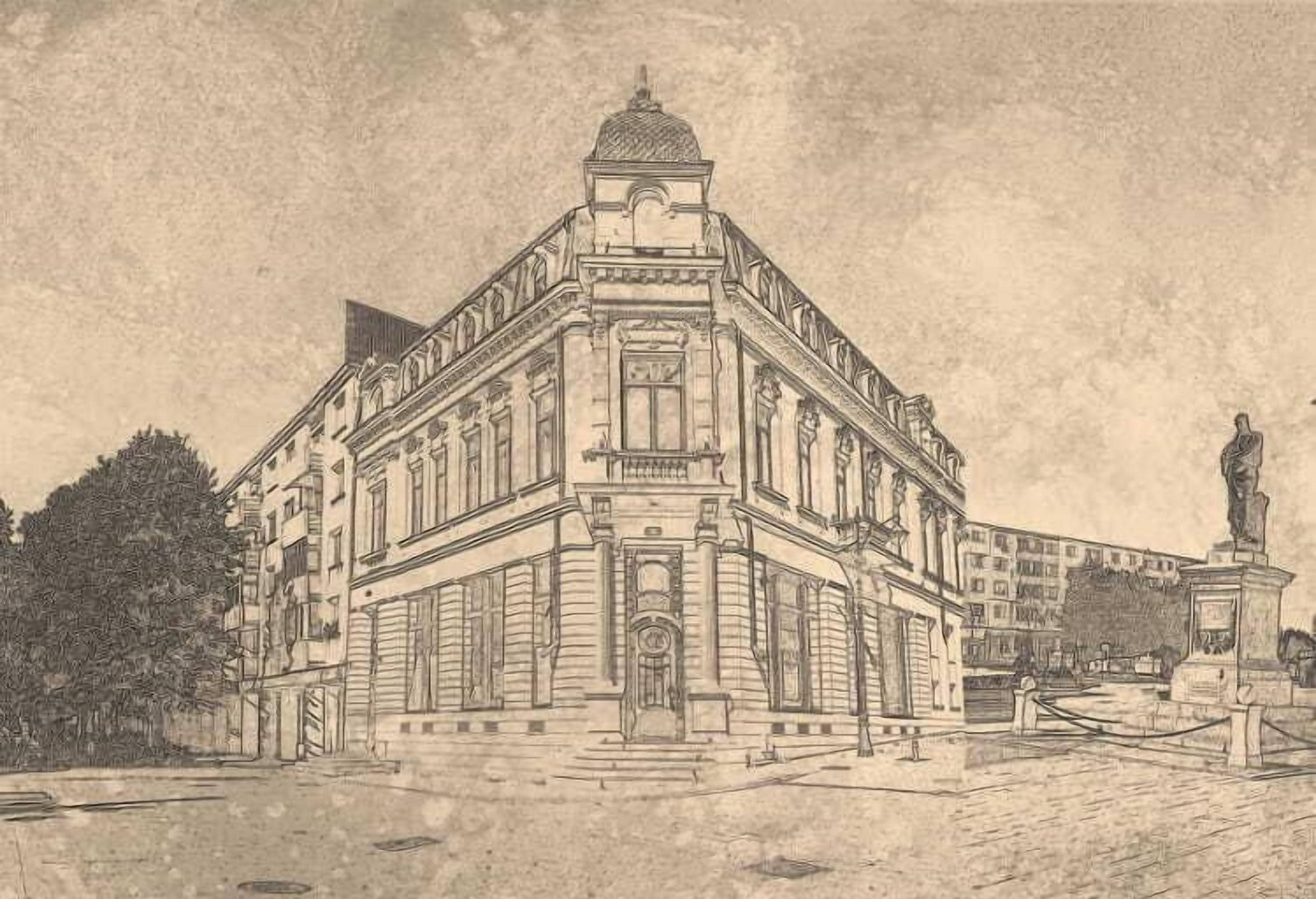 Un edificio histórico con arquitectura clásica, que presenta una entrada central destacada, ventanas grandes y una estatua en el patio.