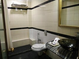 A bathroom with a toilet, a sink, and a mirror.