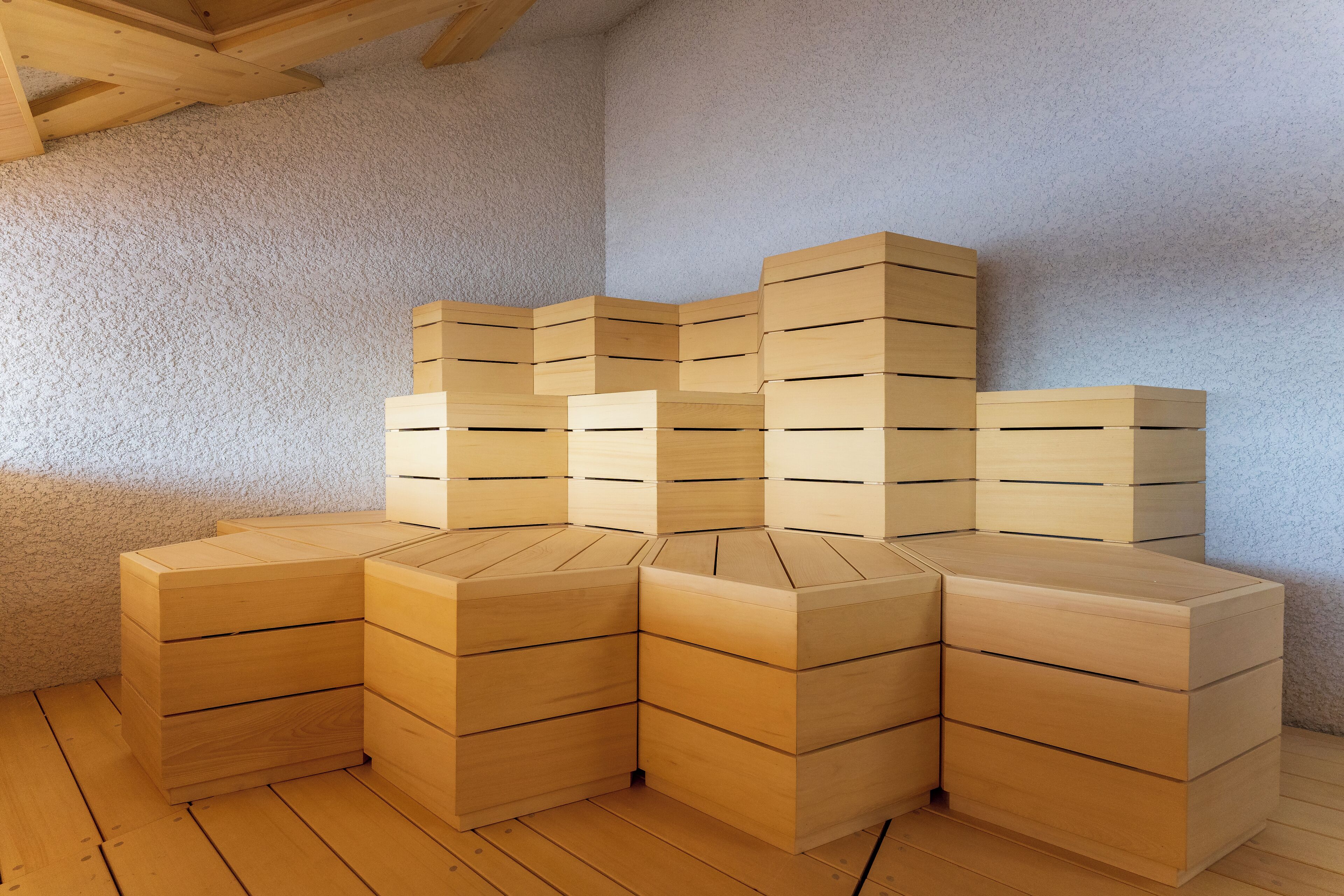 A corner of a room with wooden storage units stacked against the wall.