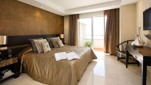 A modern hotel room with a large bed, a desk, and a view of the outdoors. - 213 Lux-Serv Apart-Estepona, 2-B'room, All Year 28c, 20m Heated Pool. Sea Views (Estepona)