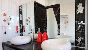 A bathroom with two large white sinks, a black mirror, and red bags on the counter. - RedDoorz near Gia Dinh Church (Ho Chi Minh City)