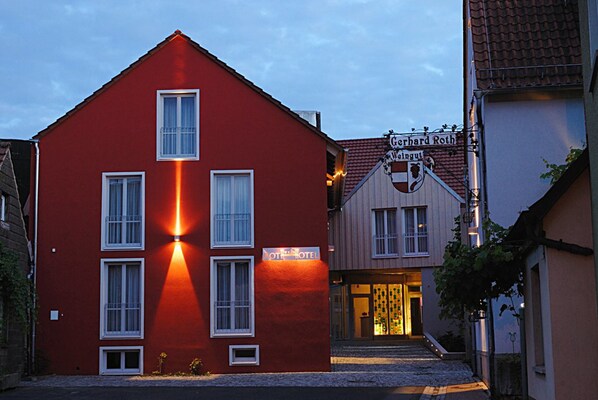 A red building with a sign for 'Hotel Roth' and 'Gerhard Rothing' visible. - RotHweinHotel (Wiesenbronn)