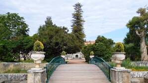 A stone bridge with a green railing leading to a gate. - Window to the Sea Oeiras (Oeiras)