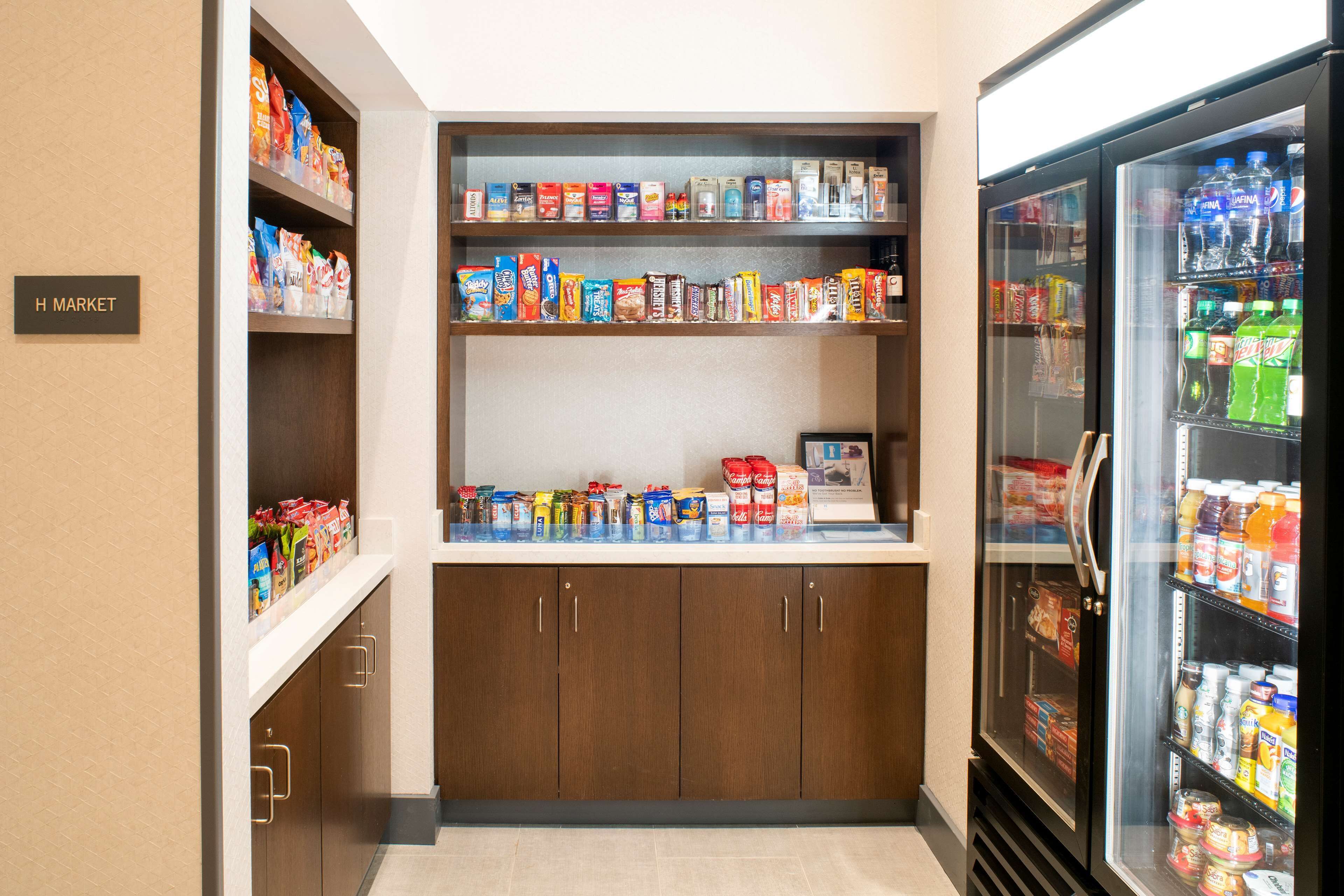 A small convenience store with shelves stocked with snacks, beverages, and other items.