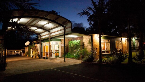 A hotel entrance with a covered walkway, a satellite dish, and a well-lit facade. - Manjimup Motor Inn (Manjimup)