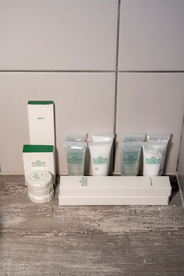 A set of skincare products including a box and several tubes, arranged on a wooden surface against a plain wall.