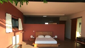 A spacious bedroom with a large bed, bedside tables, and a wooden bench. - House / Villa - Poggio d''oletta (Poggio-D'oletta)