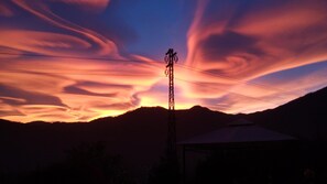 A power line tower with a clear sky and clouds. - AURORA Suite apartment Lake Orta-beach00311600048 (pettenasco)