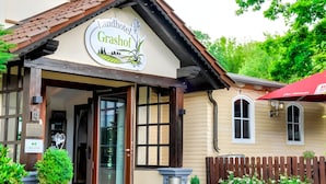 A building with a sign reading "Landhotel Grashof" and a wooden fence in the background. - Landhotel Grashof (Kalbach)