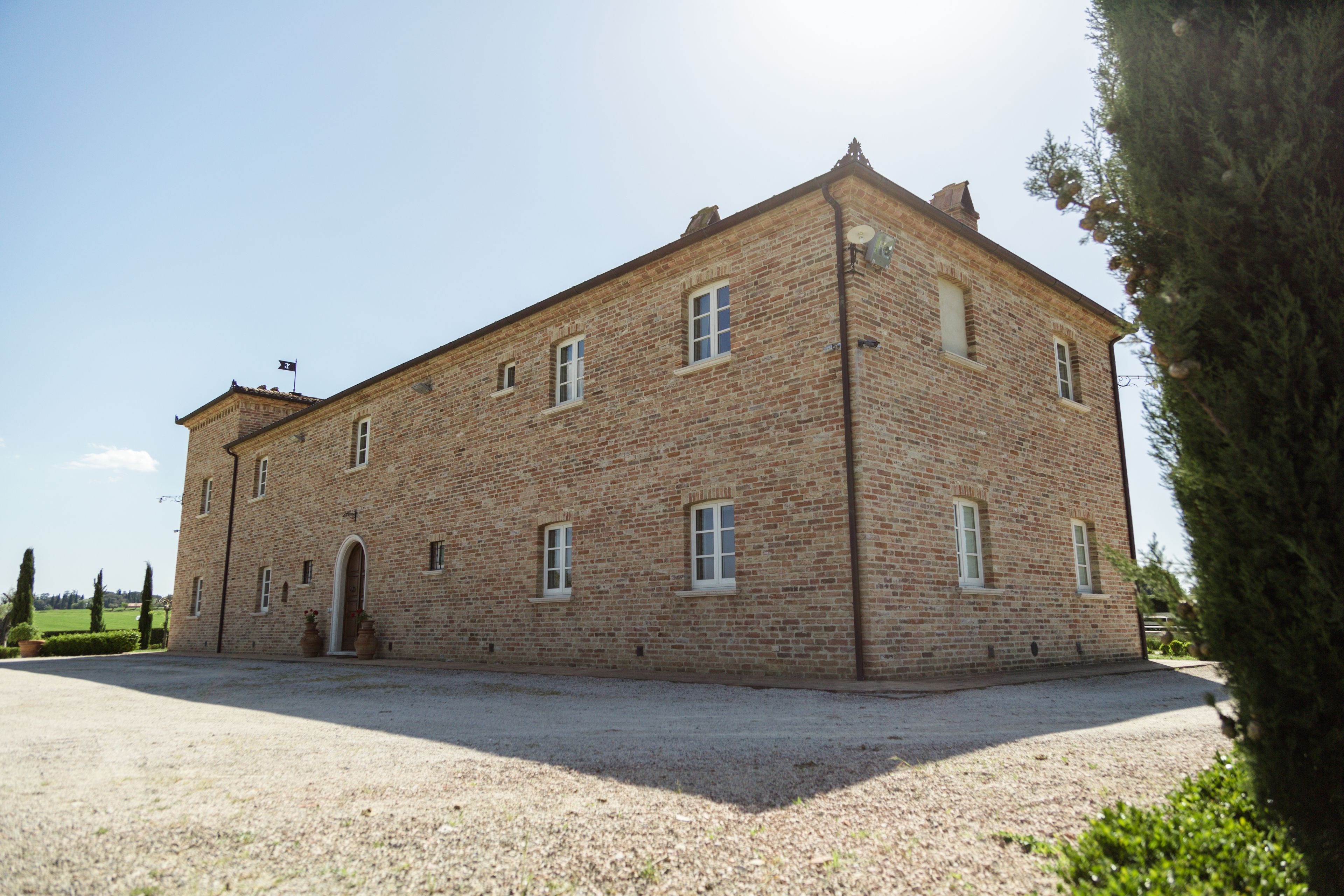 A large, rectangular brick building with multiple windows and a central entrance.