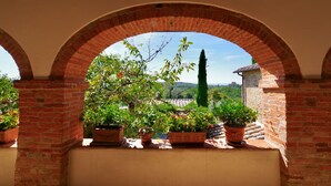 An arched brick structure with potted plants.