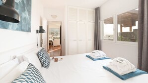 A hotel room with a large bed, two bedside tables, a wardrobe, and a view of the outside. - Plunge pool, terraces, garden, BBQ & lounge [A] (Icod de los Vinos)