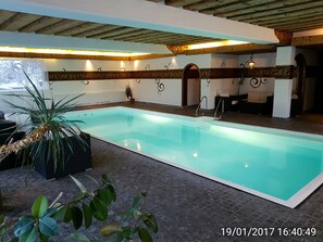 Indoor pool, a heated pool, open 9 AM to 8 PM, pool umbrellas