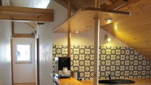 A kitchen with a wooden counter, a coffee machine, and a sink. - Close to the mountains! (Pfronten)
