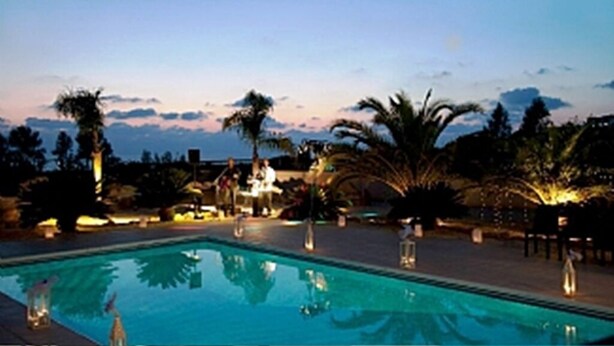 A swimming pool with palm trees and a sunset in the background. - Villa With Private Pool And Stunning Sea Views And Large Landscaped Gardens (Peyia)