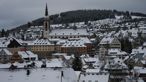 A snow-covered town with a prominent church and residential buildings. - Warm magic in the heart of the Black Forest (Titisee-Neustadt)