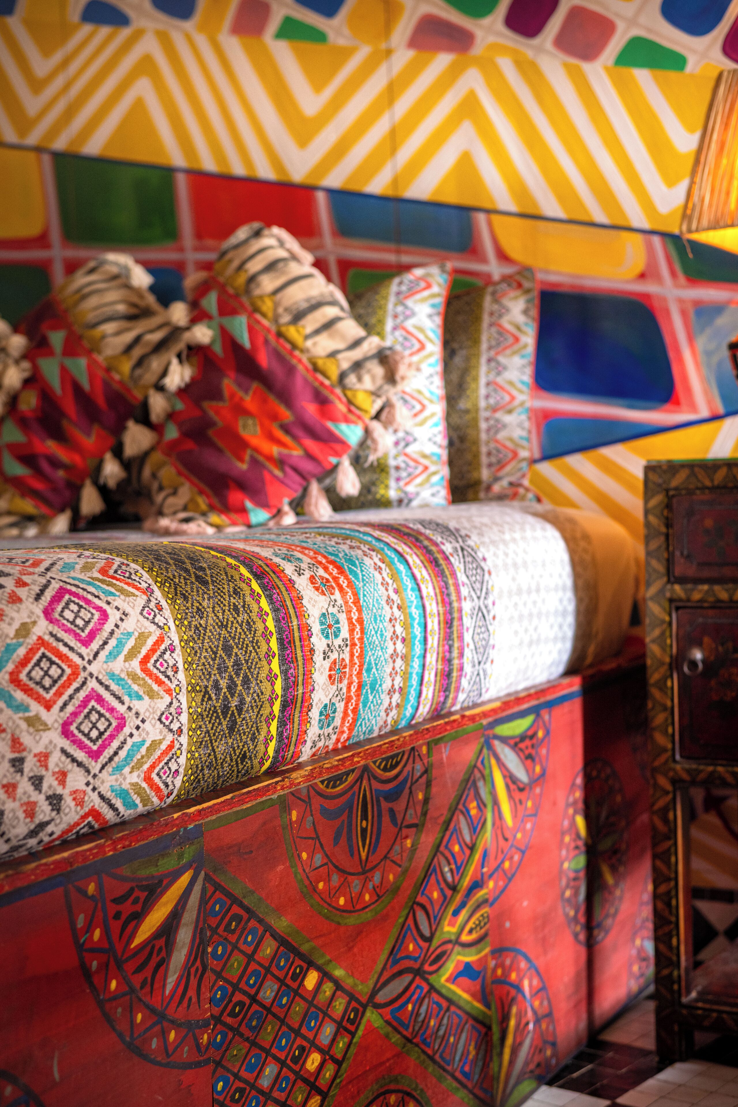 A colorful, patterned sofa with a vibrant, geometric design.
