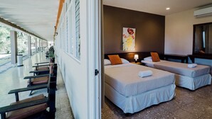 A hotel room with two beds, a large window, and a view of the outdoors. - Hotel Diriá Santa Cruz (Santa Cruz)
