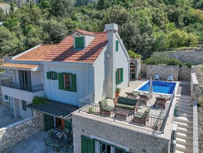 A two-story house with a swimming pool, stone walls, and green shutters. - TOP OFFER-Charming cottage with heated pool in a quiet location and sea view (Makarska)