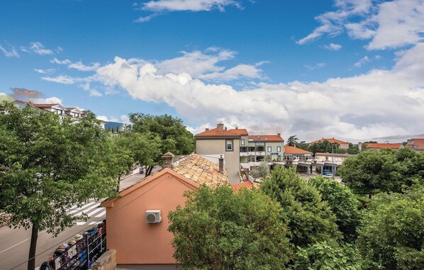 A residential area with houses, trees, and a clear sky.