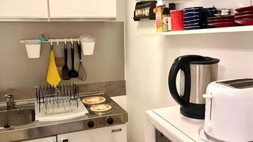 Fridge, microwave, stovetop, coffee/tea maker