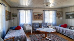 A cozy room with two single beds, a small table, two chairs, and a window with curtains. - Gorgeous home in Ambjörnarp with WiFi (Ambjörnarp)