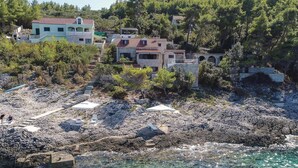 A coastal property with stone buildings, clear blue waters, and a rocky beach. - Gorgeous home in Prigradica with sauna (Prigradica)