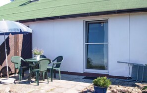 Guests can enjoy a patio with a round table and comfortable seating for four.