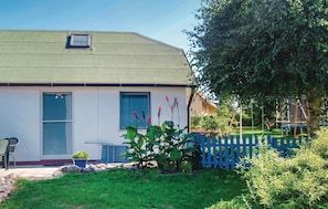 Stunning single-story home with a lush lawn and a charming picket fence.