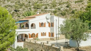 A white building with red shutters, a balcony, and a satellite dish. - Casa Ensueño - an oasis of peace with fantastic views. (Jalón)