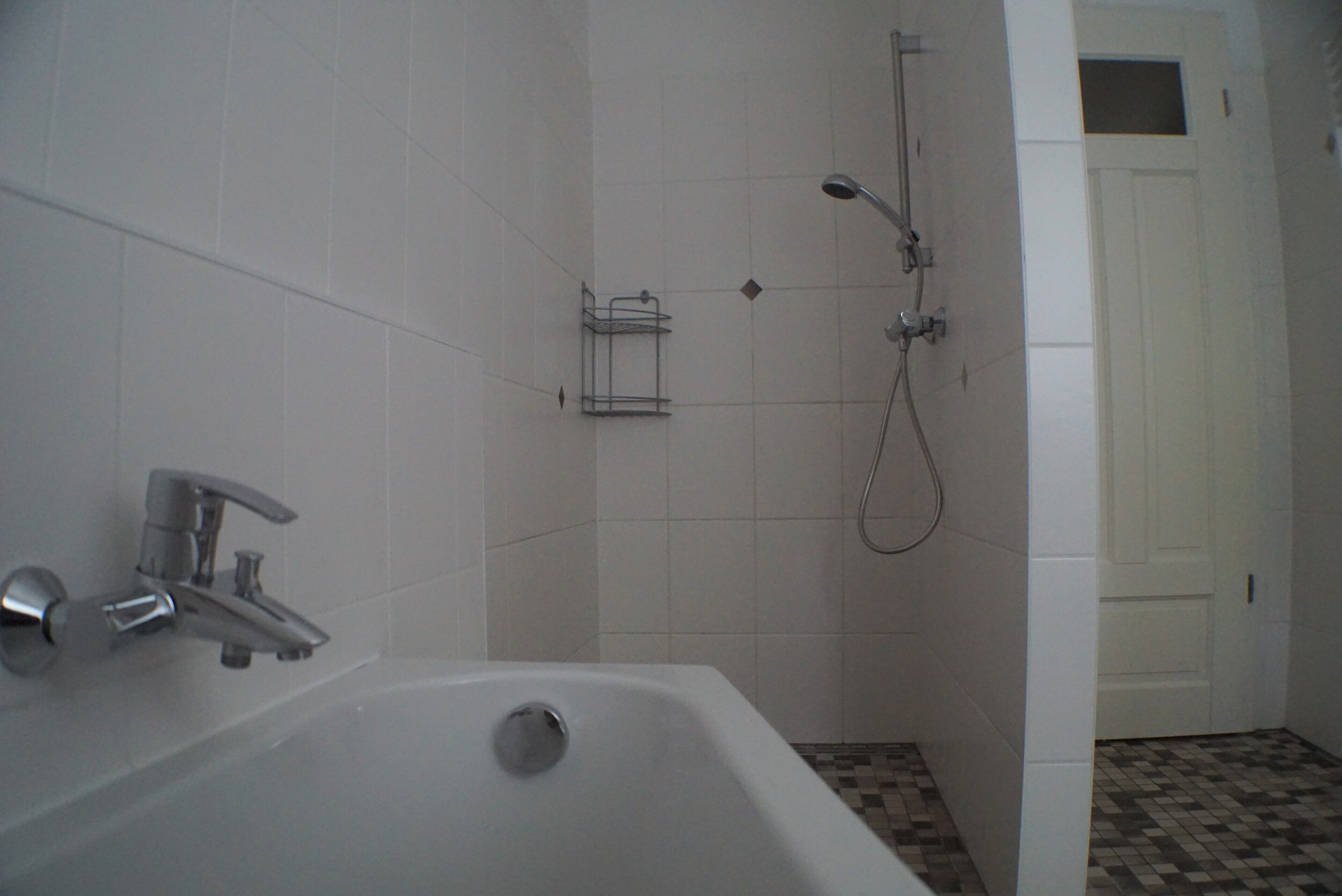 A bathroom with a bathtub, a shower, and a toilet.