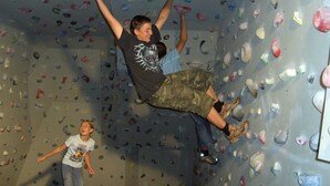 A person climbing a wall with variously shaped holds. - Fallwindes 1 - Gratzhof - Kals (Lesach)