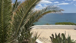A coastal view with palm trees and a clear sky. - Beautiful apartment in a quiet location with sea views  (Porches - Alporchinhos)
