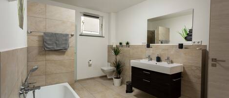 Bathtub, hair dryer, towels, soap