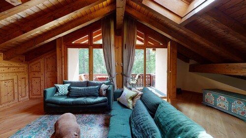 This exclusive duplex apartment right at the slope next to the forest offers app