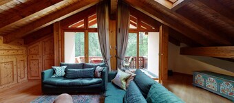 This exclusive duplex apartment right at the slope next to the forest offers app