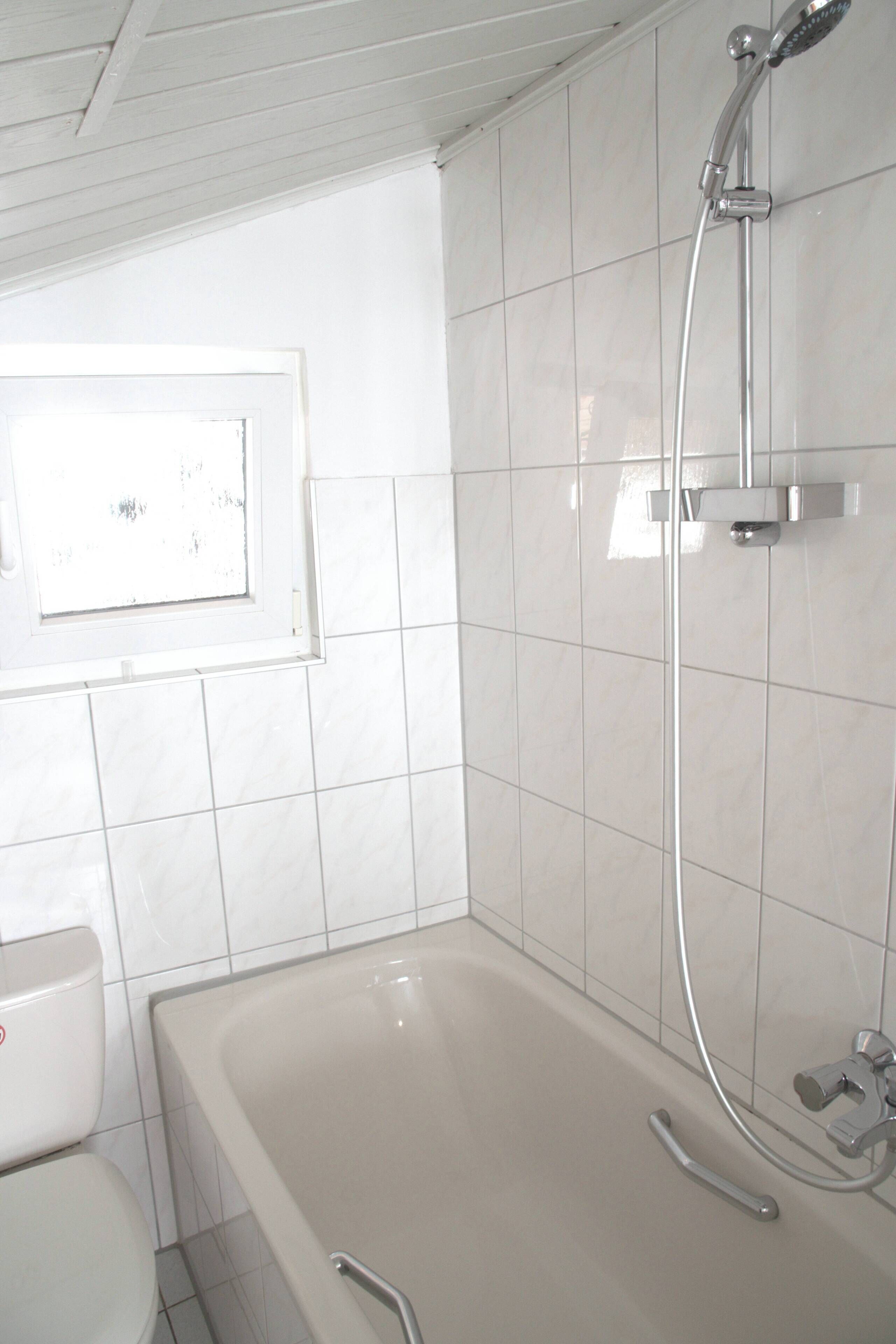 A bathroom with a bathtub, a shower, and a toilet.